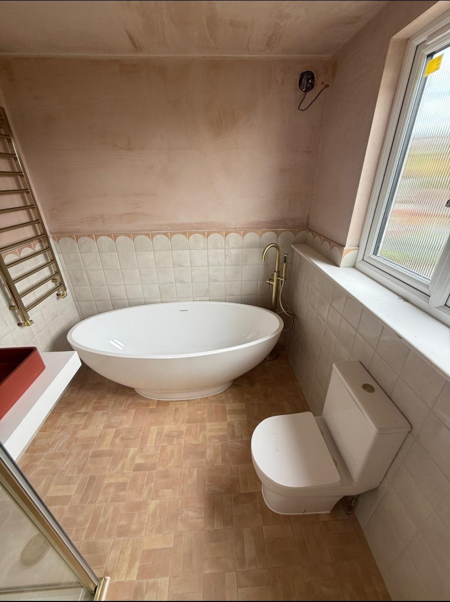 Brass, blush tile and freestanding bath.